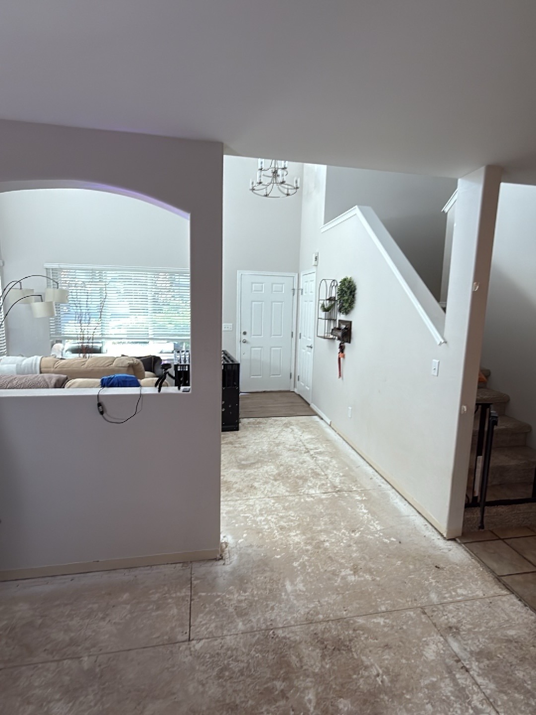 Entryway and hallway after mitigation, flooring removed to subfloor, baseboards removed